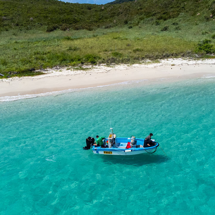 MG Kailis crew in small fishing boat off Torres Strait island, preparing for sustainable tropical rock lobster harvest in Northern Australia.